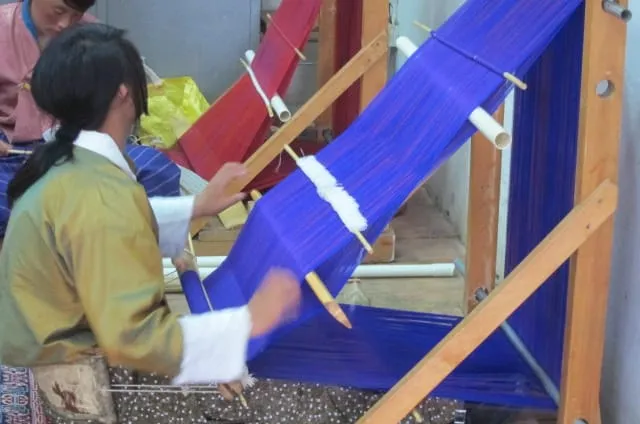 A young Bhutanese woman learning to weave.